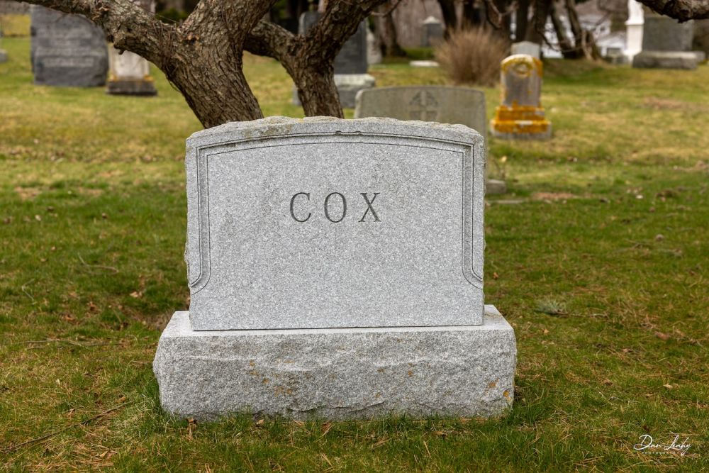 A closeup of the headstone of Cox and Cook.